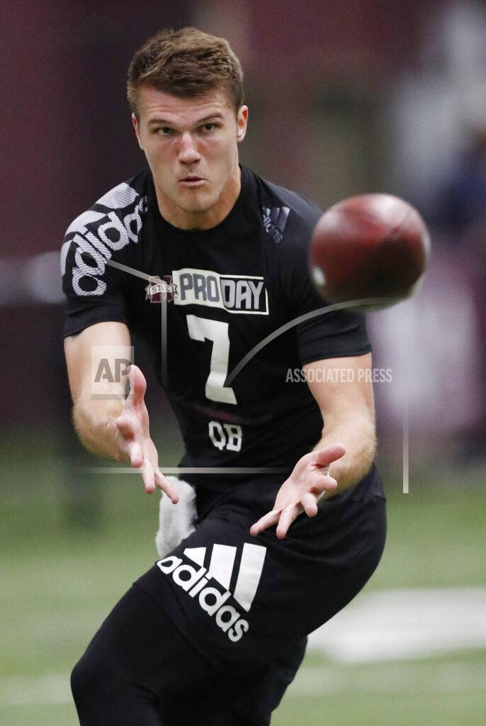 Rogelio V. Solis Former Mississippi State quarterback Nick Fitzgerald reaches for a pass while getting tested by NFL football scouts and coaches during Pro Day at Mississippi State, Wednesday, March 27, 2019, in Starkville, Miss. (AP Photo/Rogelio V. Solis)
