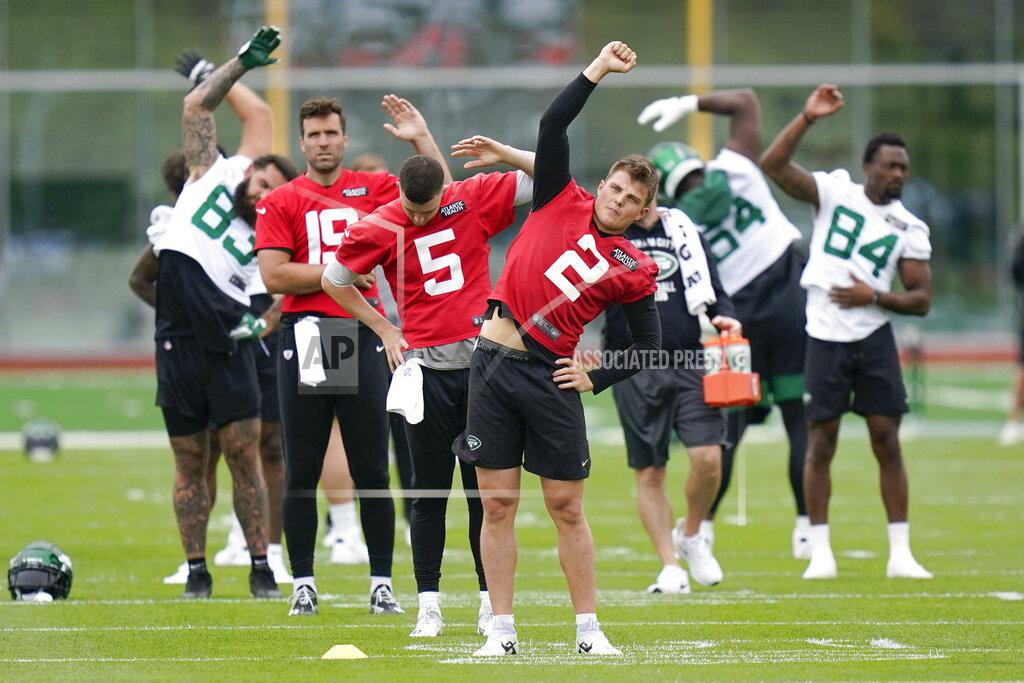 Seth Wenig New York Jets' quarterback Zach Wilson (2), front, stretches with teammates at the NFL football team's training facility in Florham Park, N.J., Tuesday, May 24, 2022. (AP Photo/Seth Wenig)