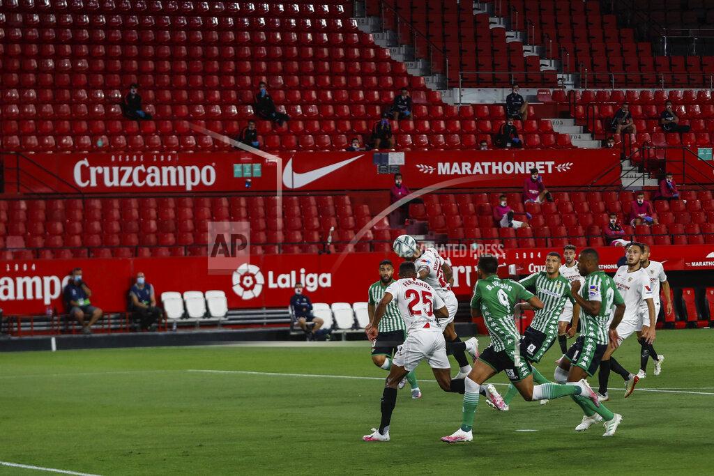 Str Sevilla and Betis players duel for the ball during their Spanish La Liga soccer match in Seville, Spain, Thursday, June 11, 2020. With virtual crowds, daily matches and lots of testing for the coronavirus, soccer is coming back to Spain. The Spanish league resumes this week more than three months after it was suspended because of the pandemic, becoming the second top league to restart in Europe. The Bundesliga was first. The Premier League and the Italian league should be next in the coming weeks. (AP Photo)