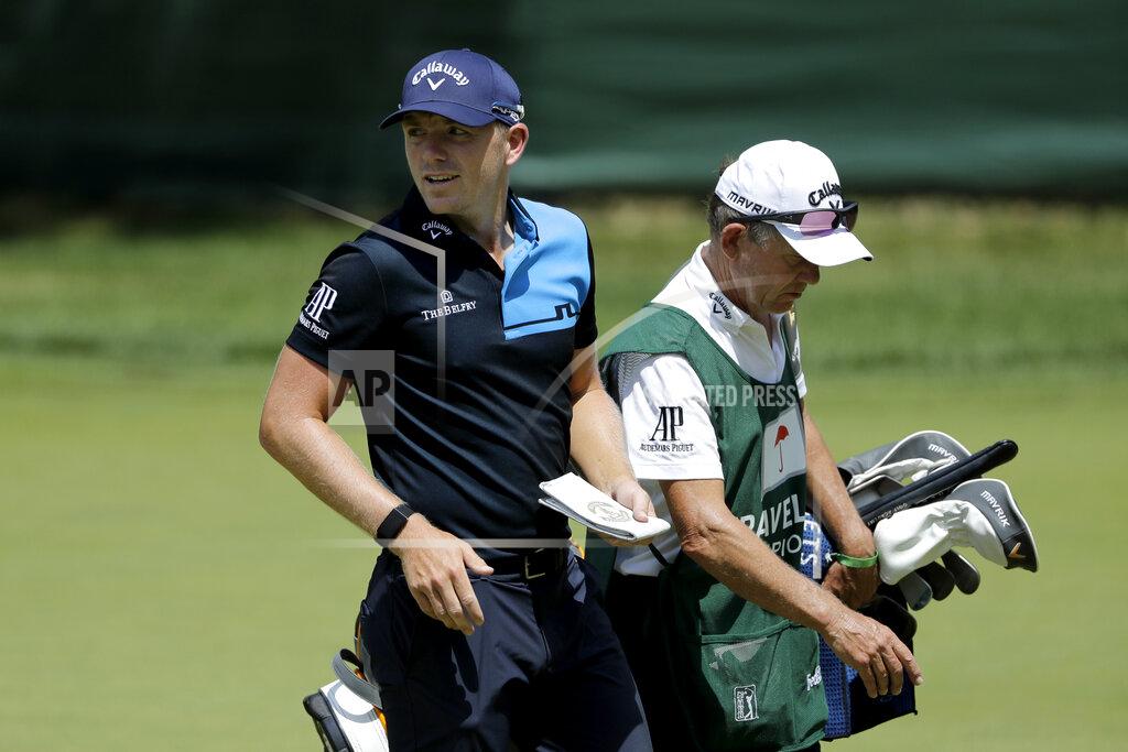 Frank Franklin Ii Matt Wallace, left, of England, walks with his caddie David McNeilly to the fourth tee box during the second round of the Travelers Championship golf tournament at TPC River Highlands, Friday, June 26, 2020, in Cromwell, Conn. Wallace is playing the second round by himself after two other golfers in his group, Denny McCarthy and Bud Cauley, withdrew from the tournament. McCarthy told Golfchannel.com that he withdrew from the tournament after feeling sick Thursday night and testing positive for the coronavirus on Friday. Cauley, who played with McCarthy on Thursday, also withdrew before Friday's second round. McCarthy became the third PGA Tour player to test positive for the virus since its restart and the second this week, joining Cameron Champ who withdrew on Tuesday. Nick Watney withdrew just before the second round of last week's RBC Heritage Championship. (AP Photo/Frank Franklin II)