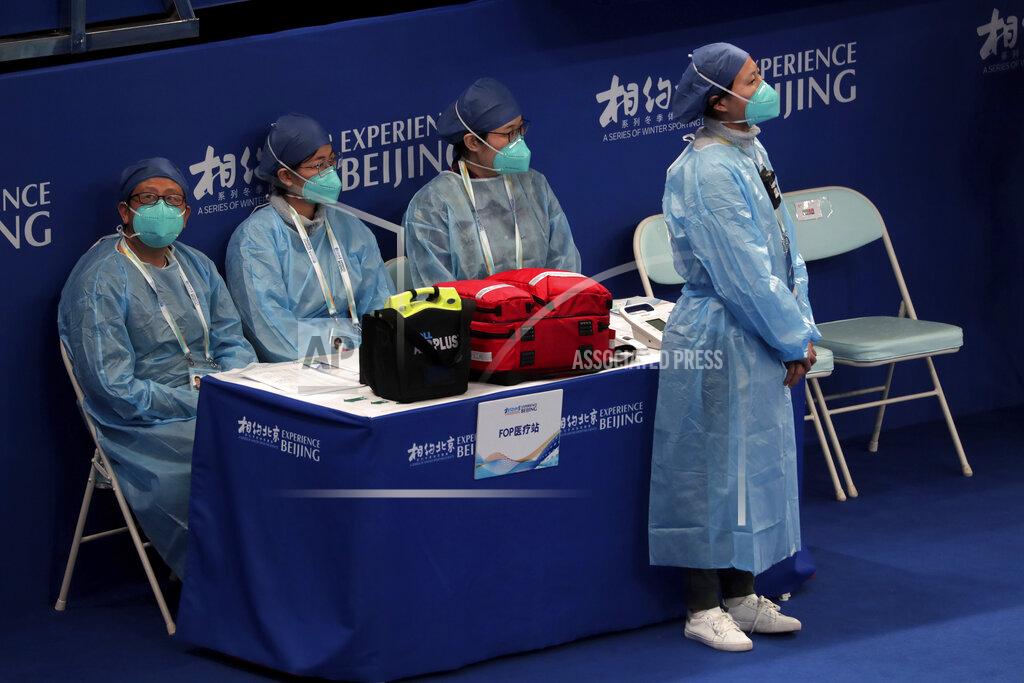 Andy Wong Medical workers wearing face masks watch players compete in a curling competition during a test event for the 2022 Beijing Winter Olympics at National Aquatic Center, also known as the "Water Cube" in Beijing, Thursday, April 1, 2021. Chinese capital hold a 10 days test events for 2022 Beijing Winter Olympics in five different venues from April 1-10, becomes the first city to hold both the Winter and Summer Olympics. (AP Photo/Andy Wong)