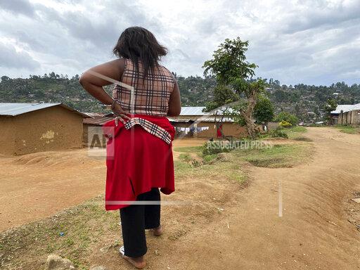 FILE - In this Thursday, March 18, 2021 file photo, Shekinah stands near her home in Beni, eastern Congo. A panel commissioned by the World Health Organization on Tuesday Sept, 28, 2021 identified more than 80 alleged cases of sex abuse during the U.N. health agency's response to an Ebola outbreak in Congo, including allegations implicating 20 WHO staff members. (AP Photo/Kudra Maliro, File)