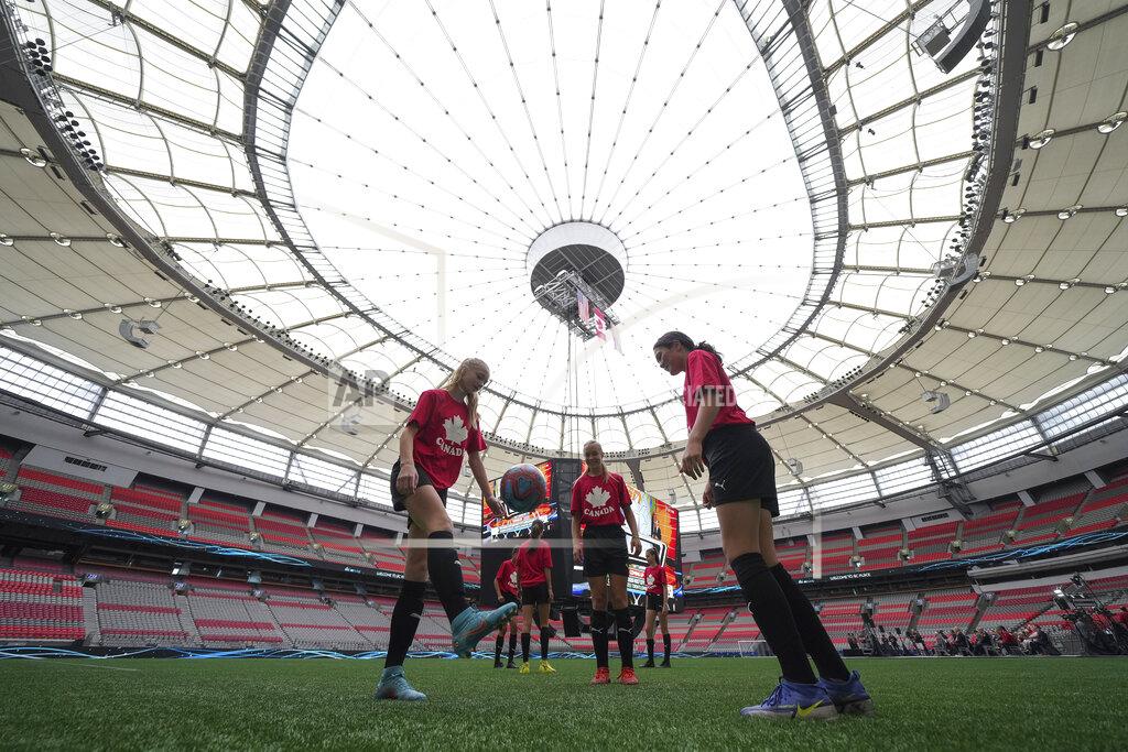 Darryl Dyck Youth soccer players kick a ball around on the field at B.C. Place stadium during a gathering to watch as Vancouver was chosen as one of the host cities for the 2026 FIFA World Cup soccer tournament, Thursday, June 16, 2022, at B.C. Place stadium in Vancouver, British Columbia. (Darryl Dyck/The Canadian Press via AP)