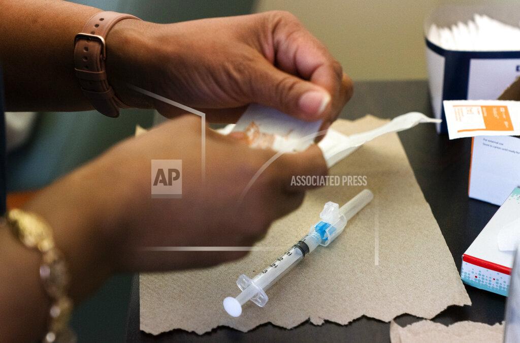 Jacquelyn Martin In this Wednesday, Feb. 10, 2021, photo nurse Michelle Martin prepares a COVID-19 vaccination for Wallace Charles Smith, 72, who is a pastor at Shiloh Baptist Church at United Medical Center in southeast Washington. (AP Photo/Jacquelyn Martin)
