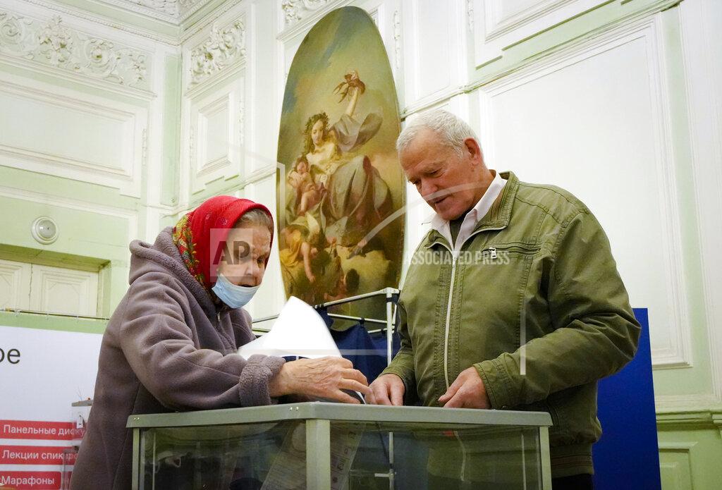 Dmitri Lovetsky People cast their ballots during the State Duma, the Lower House of the Russian Parliament and local parliaments elections at a polling station situated in an old palace in St. Petersburg, Russia, Saturday, Sept. 18, 2021. Sunday will be the last of three days voting for a new parliament, but there seems to be no expectation that United Russia, the party devoted to President Vladimir Putin, will lose its dominance in the State Duma. (AP Photo/Dmitri Lovetsky)