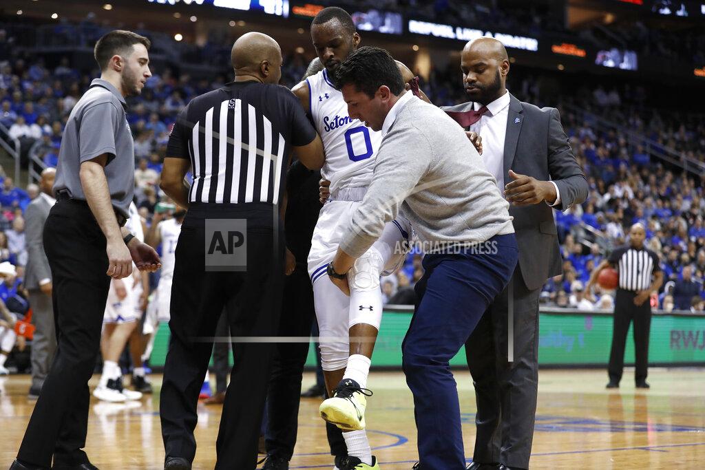 Michael Owens Seton Hall's Quincy McKnight (0) is assisted off of the court after being injured against Xavier's Tyrique Jones (not pictured) during the second half of an NCAA college basketball game, Saturday, Feb. 1, 2020, in Newark, N.J. Xavier won, 74-62. (AP Photo/Michael Owens)