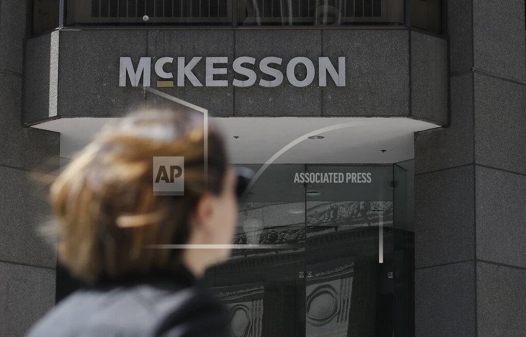 Jeff Chiu FILE - In this July 17, 2019 file photo, a pedestrian passes a McKesson sign on an office building in San Francisco. Four companies say they'll move ahead with a $26 billion settlement of lawsuits over the opioid crisis. An announcement from drug distributors AmerisourceBergen, Cardinal Health and McKesson came Saturday, Sept. 4, 2021. (AP Photo/Jeff Chiu, File)