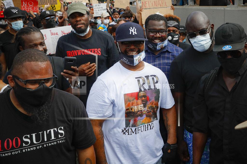 John Minchillo Terrence Floyd, center, brother of the deceased George Floyd, marches onto the Brooklyn Bridge after a rally at Cadman Plaza Park, Thursday, June 4, 2020, in the Brooklyn borough of New York. Protests continued following the death of George Floyd, who died after being restrained by Minneapolis police officers on May 25. (AP Photo/John Minchillo)