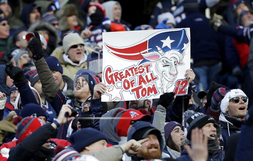 Elise Amendola Fans cheer and hold a sign referring to New England Patriots quarterback Tom Brady during the second half of an NFL divisional playoff football game between the Los Angeles Chargers and the Patriots, Sunday, Jan. 13, 2019, in Foxborough, Mass. (AP Photo/Elise Amendola)