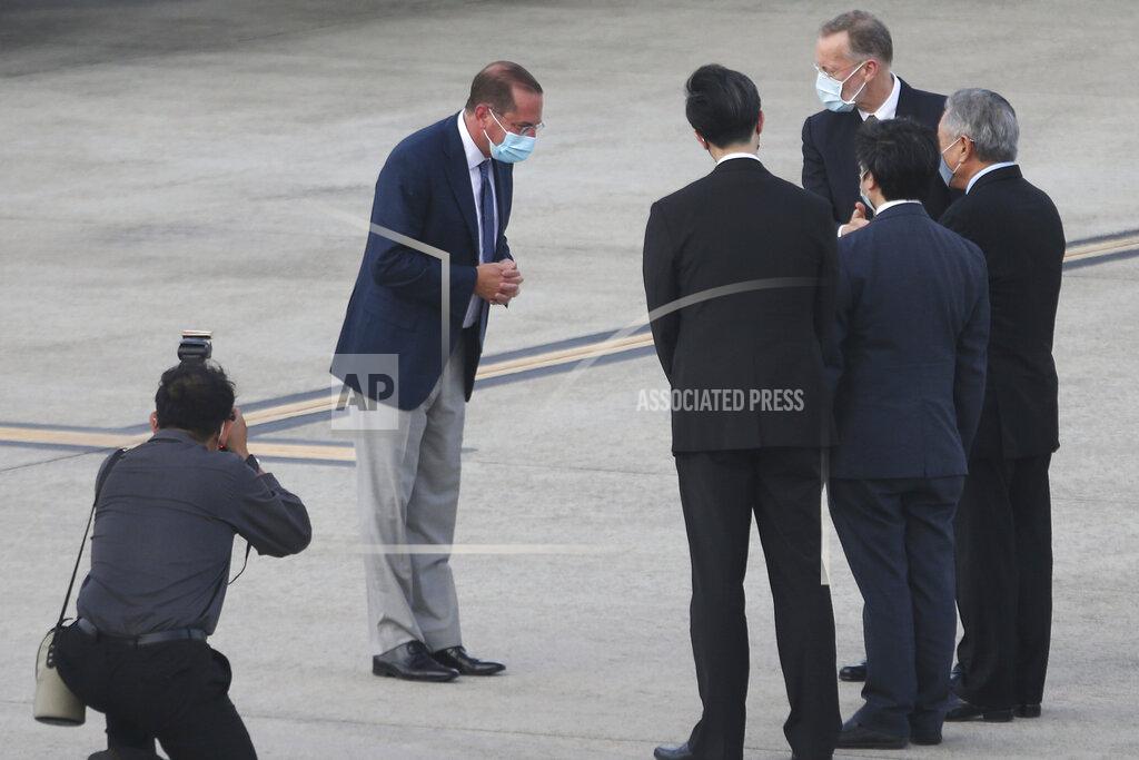 Chiang Ying-Ying U.S. Health and Human Services Secretary Alex Azar, second left, greets Taiwanese officers as he arrives at Taipei Songshan Airport in Taipei, Taiwan, Sunday, Aug. 9, 2020. Azar arrived in Taiwan on Sunday in the highest-level visit by an American Cabinet official since the break in formal diplomatic relations between Washington and Taipei in 1979. (AP Photo/Chiang Ying-ying)