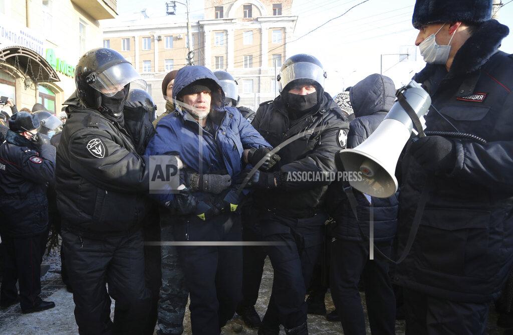 Uncredited Police detain a man during a protest against the jailing of opposition leader Alexei Navalny in Siberian city of Omsk, Russia, Saturday, Jan. 23, 2021. Russian police on Saturday arrested hundreds of protesters who took to the streets in temperatures as low as minus-50 C (minus-58 F) to demand the release of Alexei Navalny, the country's top opposition figure. Navalny, President Vladimir Putin's most prominent foe, was arrested on Jan. 17 when he returned to Moscow from Germany, where he had spent five months recovering from a severe nerve-agent poisoning that he blames on the Kremlin. (AP Photo)