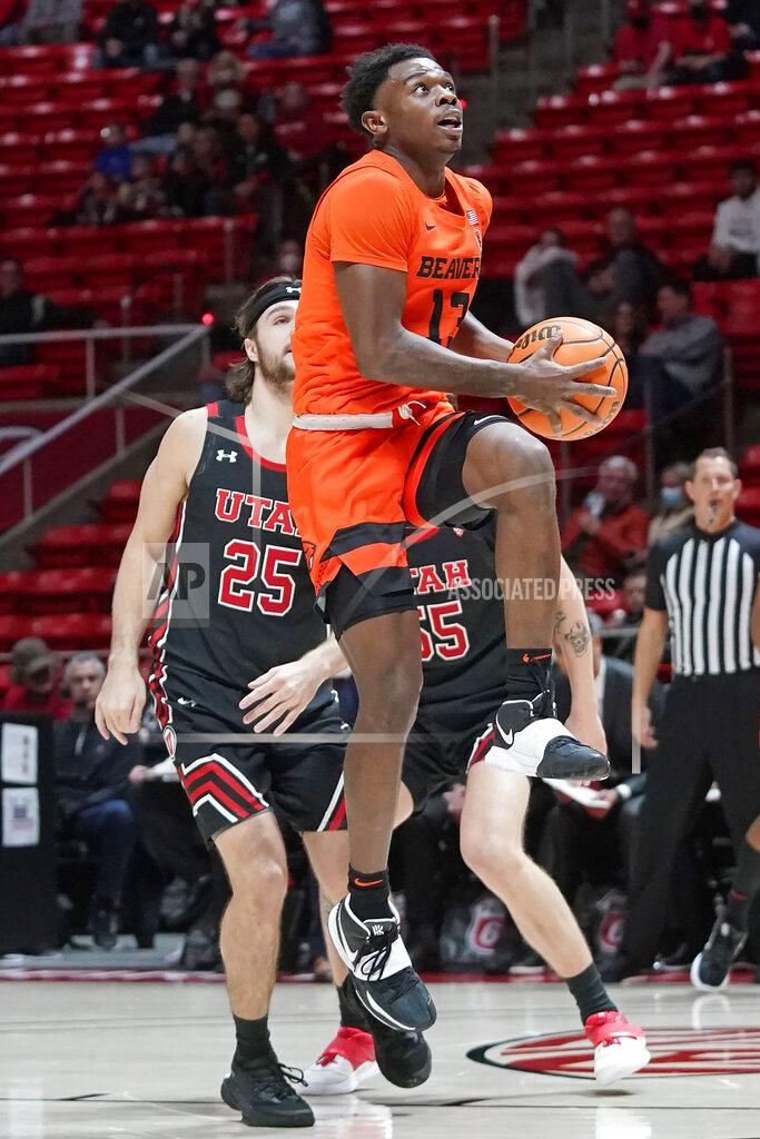 Rick Bowmer Oregon State guard Dashawn Davis (13) goes to the basket as Utah guard Rollie Worster (25) looks on in the first half during an NCAA college basketball game Thursday, Feb. 3, 2022, in Salt Lake City. (AP Photo/Rick Bowmer)