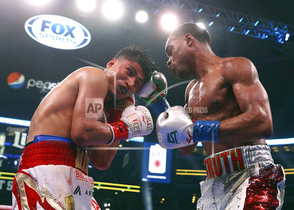 Mikey Garcia, left, takes a blow to the head from Errol Spence Jr. during the 12th round of the IBF welterweight championship boxing bout Saturday, March 16, 2019, in Arlington, Texas. (AP Photo/Richard W. Rodriguez)