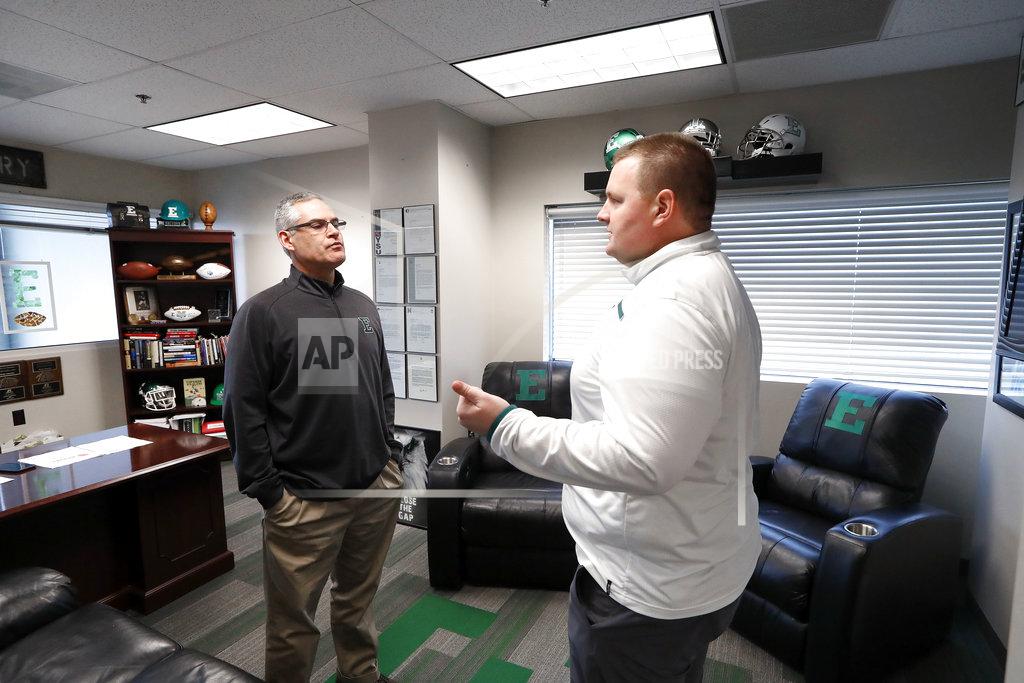 Paul Sancya Eastern Michigan football coach Chris Creighton, left, listens to defensive line coach Ben Needham in Ypsilanti, Mich., Monday, Dec. 10, 2018. Eastern Michigan's football team has stepped out of the shadows created by the neighboring University of Michigan and four professional teams just down the road in the Motor City. (AP Photo/Paul Sancya)