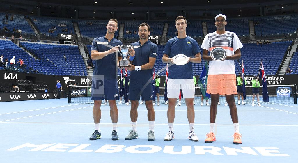 Andy Brownbill Slovakia's Filip Polasek, left, and Croatia's Ivan Dodig, second left, pose with their trophy after defeating Rajeev Ram, right, of the US and Britain's Joe Salisbury in the men's doubles final at the Australian Open tennis championship in Melbourne, Australia, Sunday, Feb. 21, 2021.(AP Photo/Andy Brownbill)