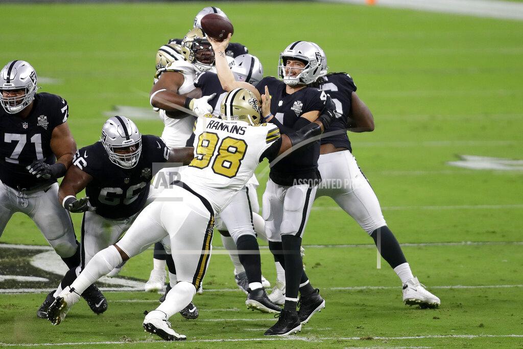 Isaac Brekken Las Vegas Raiders quarterback Derek Carr (4) throws the ball over New Orleans Saints defensive tackle Sheldon Rankins (98) during the first half of an NFL football game, Monday, Sept. 21, 2020, in Las Vegas. (AP Photo/Isaac Brekken)