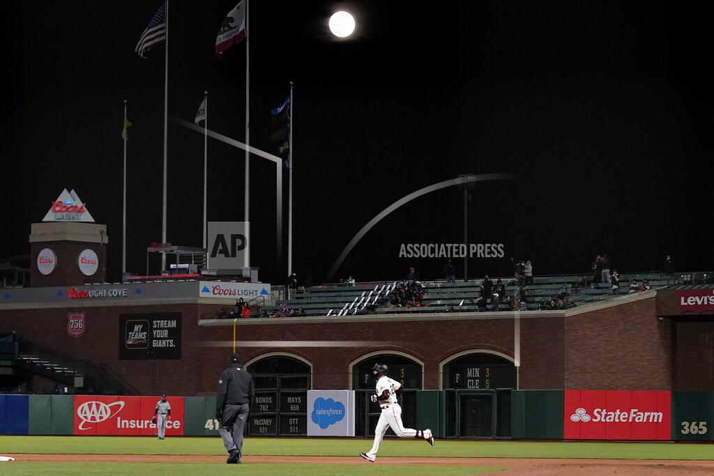 Jeff Chiu San Francisco Giants' Buster Posey, bottom, rounds the bases under a Supermoon, meaning it appears larger than an average full moon because it is nearer the closest point of its orbit to Earth, after hitting a two-run home run against the Colorado Rockies during the sixth inning of a baseball game in San Francisco, Monday, April 26, 2021. (AP Photo/Jeff Chiu)