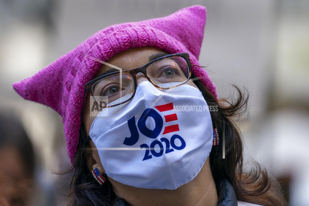 Mary Altaffer Demonstrators rally during the Women's March outside the New York Stock Exchange, Saturday, Oct. 17, 2020, in New York. Dozens of Women's March rallies were planned from New York to San Francisco to signal opposition to President Donald Trump and his policies, including the push to fill the seat of late Supreme Court Justice Ruth Bader Ginsburg before Election Day. (AP Photo/Mary Altaffer)