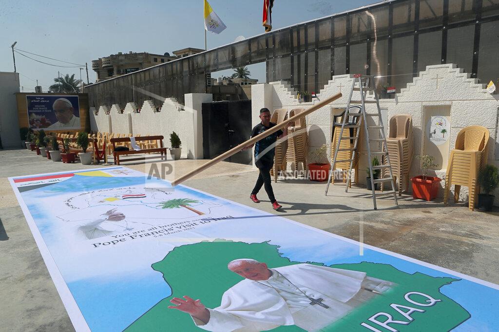 Khalid Mohammed Posters welcoming Pope Francis are prepared at St. Joseph's Chaldean Church ahead of the Pope's visit, in Baghdad, Iraq, Tuesday, March 2, 2021. (AP/Photo/Khalid Mohammed)
