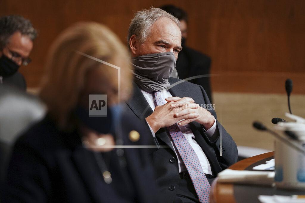 Greg Nash Sen. Tim Kaine, D-Va., listens to Surgeon General Jerome Adams give an opening statement during a Senate Health, Education, Labor and Pensions Committee hearing to discuss vaccines and protecting public health during the coronavirus pandemic on Capitol Hill, Wednesday, Sept. 9, 2020, in Washington. (Greg Nash/Pool via AP)