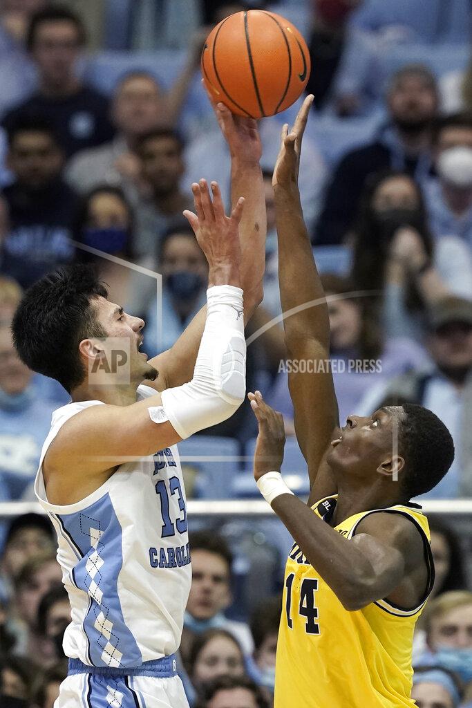 Gerry Broome North Carolina forward Dawson Garcia (13) shoots while Michigan forward Moussa Diabate (14) defends during the second half of an NCAA college basketball game in Chapel Hill, N.C., Wednesday, Dec. 1, 2021. (AP Photo/Gerry Broome)
