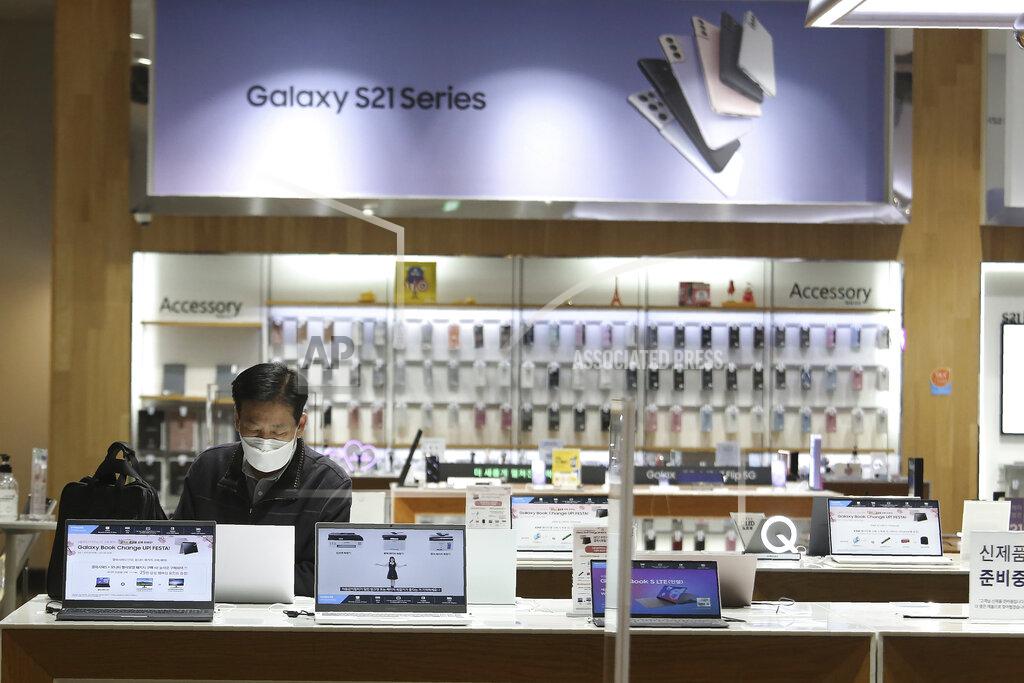 Ahn Young-Joon A visitor tries out Samsung Electronics' notebooks at its shop in Seoul, South Korea Wednesday, April 28, 2021. Samsung Electronics said Thursday its operating profit for the last quarter jumped 46% from a year earlier driven by increased sales of smartphones and televisions as its business continues to flourish amid the pandemic. (AP Photo/Ahn Young-joon)