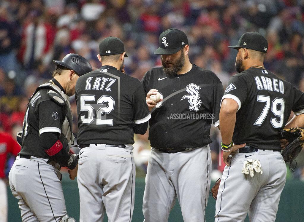 Phil Long Chicago White Sox pitching coach Ethan Katz (52) has a meeting with starting pitcher Lance Lynn, center, as Yasmani Grandal, left, and Jose Abreu listen in during the sixth inning of a baseball game in Cleveland, Saturday, Sept. 25, 2021. (AP Photo/Phil Long)