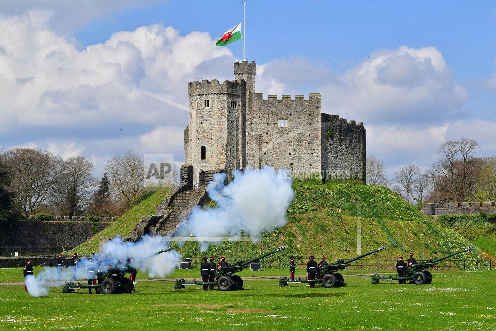 Ben Birchall Members of the 104th Regiment Royal Artillery fire a 41-round gun salute in the grounds of Cardiff Castle, to mark the death of Prince Philip, in Cardiff, Saturday, April 10, 2021. Britain's Prince Philip, the irascible and tough-minded husband of Queen Elizabeth II who spent more than seven decades supporting his wife in a role that mostly defined his life, died on Friday. (Ben Birchall/PA via AP)