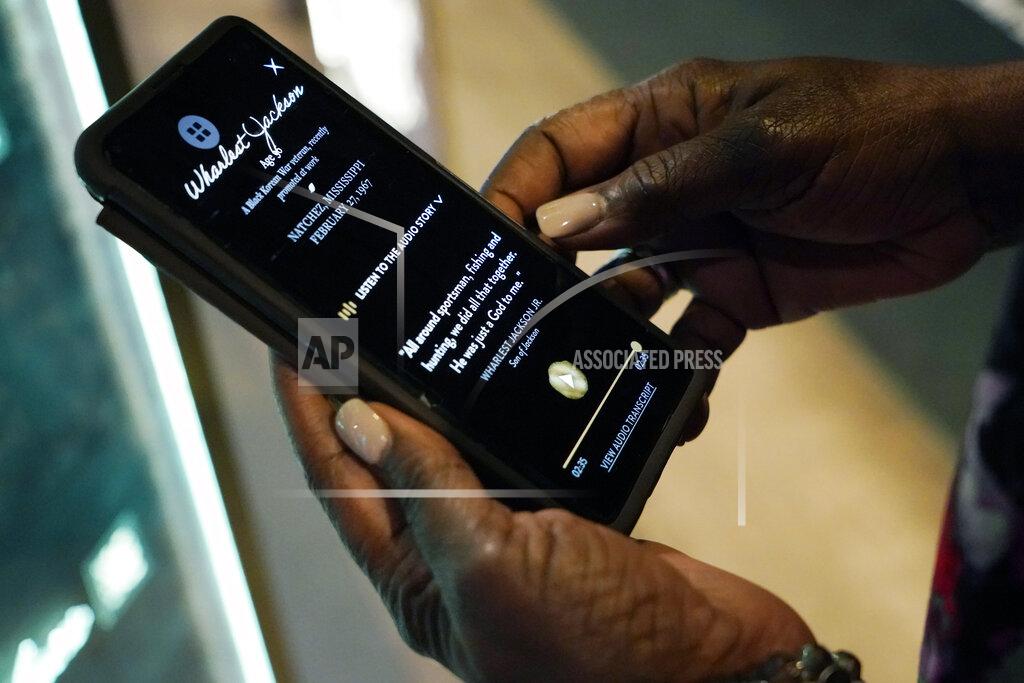 Rogelio V. Solis Pamela D.C. Junior, director of the Two Mississippi Museums in Jackson, downloads the cold case selection of Wharlest Jackson, a local NAACP leader who was killed in 1967 by a car bomb, from the PBS Frontline's traveling augmented-reality exhibit, "Un(re)solved" in the museum's special exhibit room, Friday, Aug. 27, 2021. The exhibit opened Saturday, Aug. 28, to align with the commemoration of the death of Emmett Till, a Chicago teenager who was lynched in Mississippi in 1955. The multi-media platform examines the federal government's efforts to investigate more than 150 civil rights era cold cases on the Emmett Till Unsolved Civil Rights Crime Act. (AP Photo/Rogelio V. Solis)