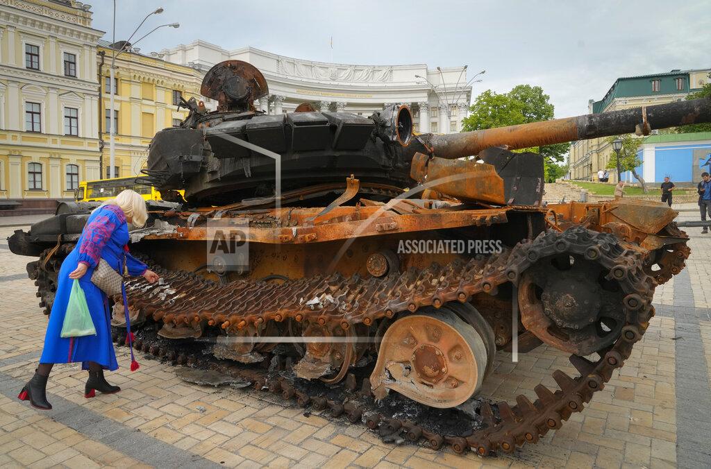Efrem Lukatsky A woman looks at a destroyed Russian tank installed as a symbol of war in central Kyiv, Ukraine, Friday, May 20, 2022. (AP Photo/Efrem Lukatsky)