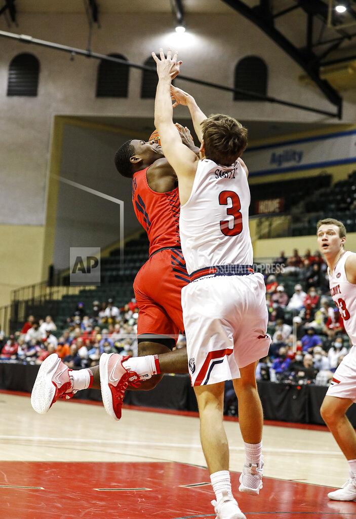 Jacob M. Langston Dayton guard Malachi Smith , left, drives against Belmont guard Luke Smith (3) as Belmont center Nick Muszysnki, right, looks on during the first half of an NCAA college basketball game Sunday, Nov. 28, 2021, in Lake Buena Vista, Fla. (AP Photo/Jacob M. Langston)