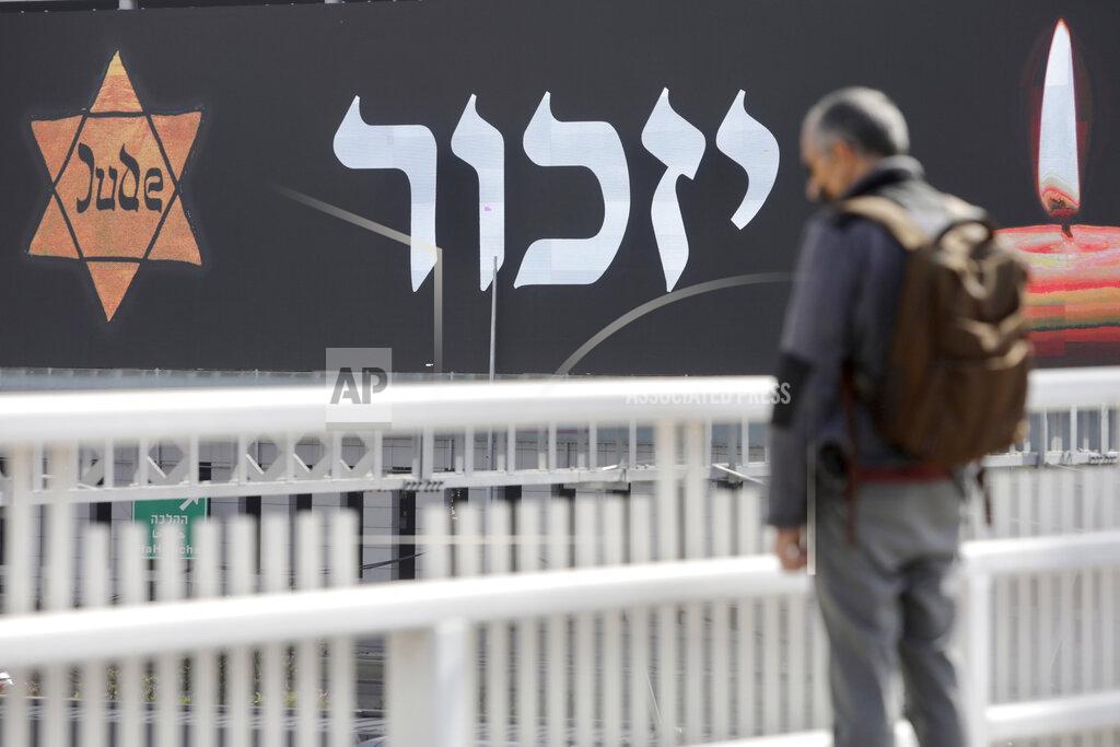 Sebastian Scheiner An Israeli stands as sirens mark a nationwide moment of silence in remembrance of the 6 million Jewish victims of the Holocaust, in Tel Aviv, Israel, Thursday, April 8, 2021. (AP Photo/Sebastian Scheiner)