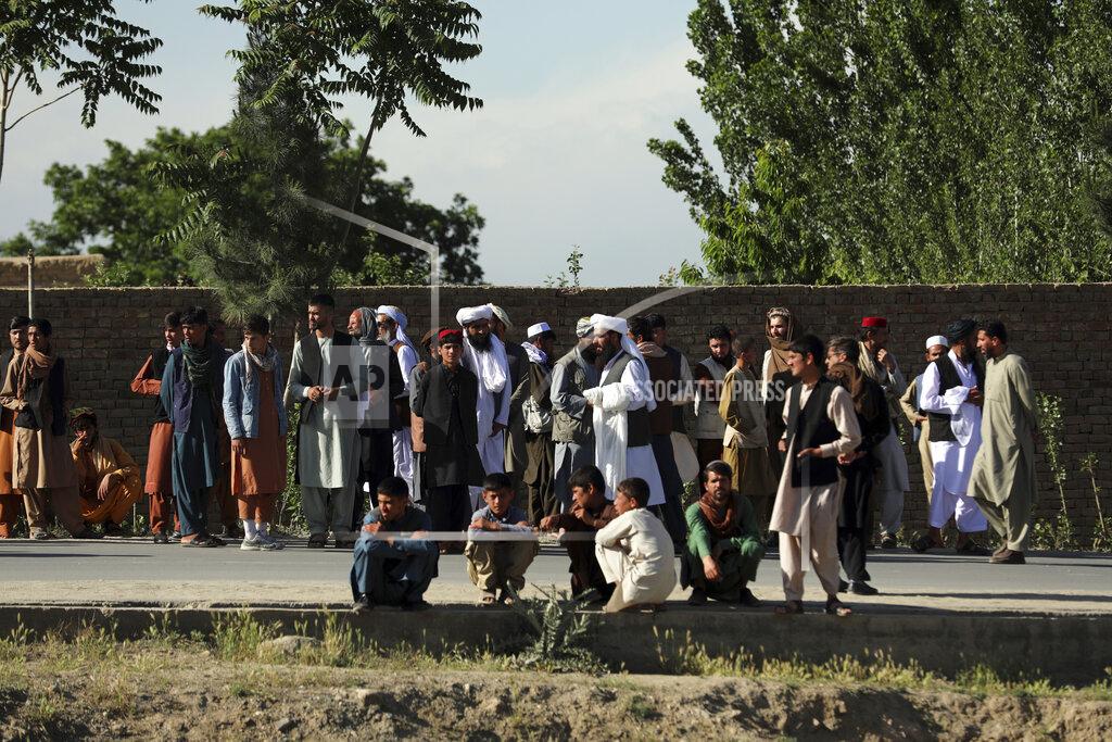Rahmat Gul Afghans stand near to mosque after a bomb explosion in Shakar Dara district of Kabul, Afghanistan, Friday, May 14, 2021. A bomb ripped through a mosque in northern Kabul during Friday prayers killing 12 worshippers, Afghan police said. (AP Photo/Rahmat Gul)