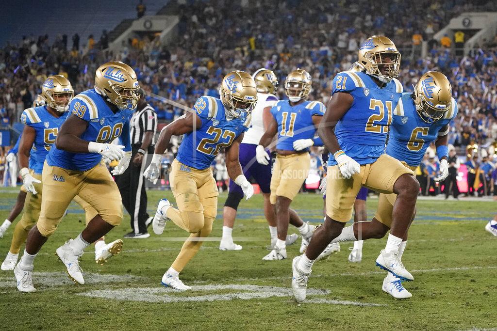Marcio Jose Sanchez UCLA linebacker JonJon Vaughns (21) celebrates after intercepting a pass from Washington quarterback Michael Penix Jr. during the first half of an NCAA college football game Friday, Sept. 30, 2022, in Pasadena, Calif. (AP Photo/Marcio Jose Sanchez)