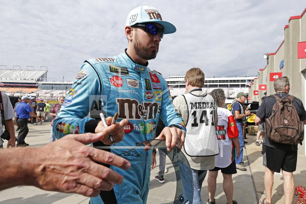 Gerry Broome Kyle Busch gives autographs to fans during practice for Sunday's NASCAR Cup Series auto race at Charlotte Motor Speedway in Concord, N.C., Saturday, Sept. 28, 2019. (AP Photo/Gerry Broome)