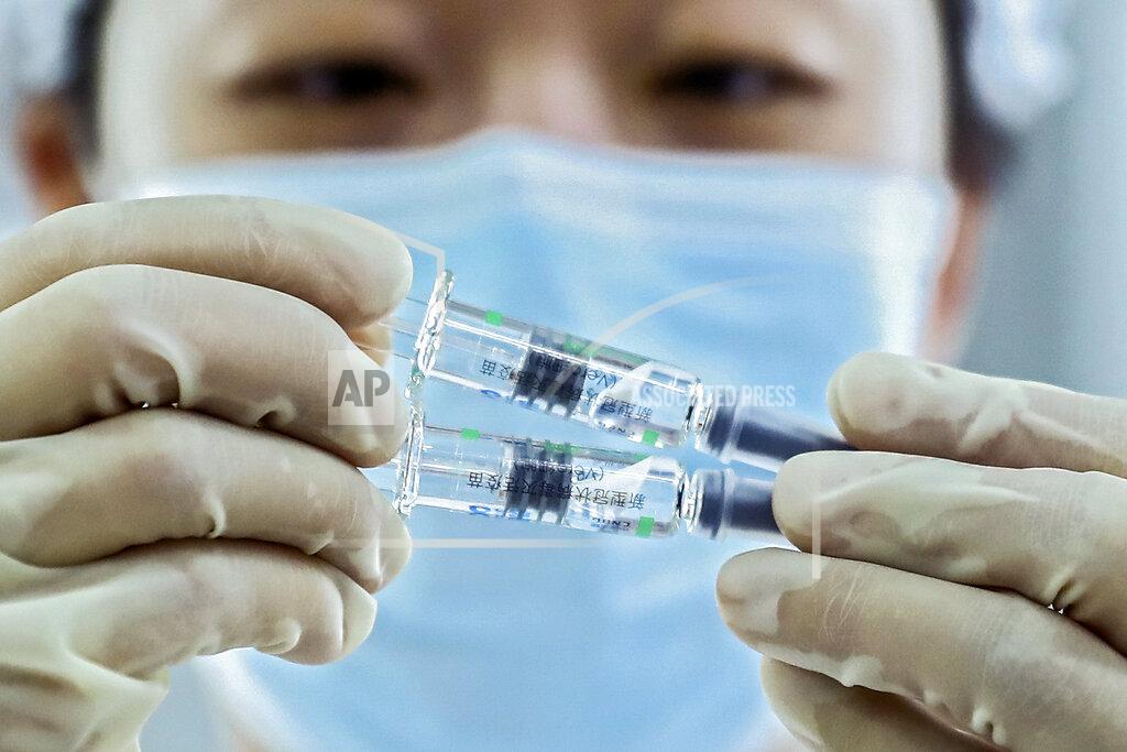 Zhang Yuwei In this photo released by Xinhua News Agency, a medical worker inspects COVID-19 inactivated vaccines at a packaging plant of the Beijing Biological Products Institute Co., Ltd. in Beijing on Dec. 25, 2020. China on Wednesday, Feb. 3 announced a plan to provide 10 million coronavirus vaccine doses to developing nations through the global COVAX initiative. (Zhang Yuwei/Xinhua via AP)