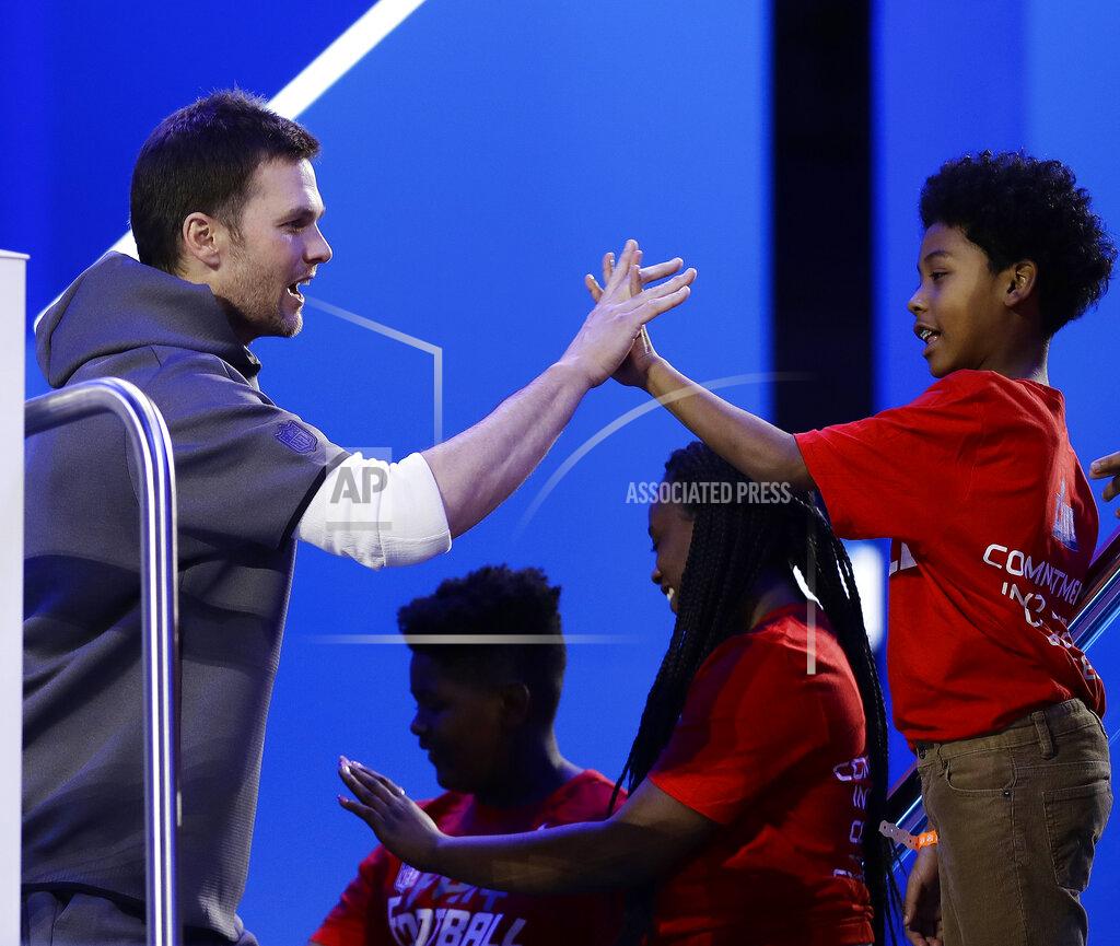 Matt Rourke New England Patriots' Tom Brady high fives some kids during Opening Night for the NFL Super Bowl 53 football game Monday, Jan. 28, 2019, in Atlanta. (AP Photo/Matt Rourke)