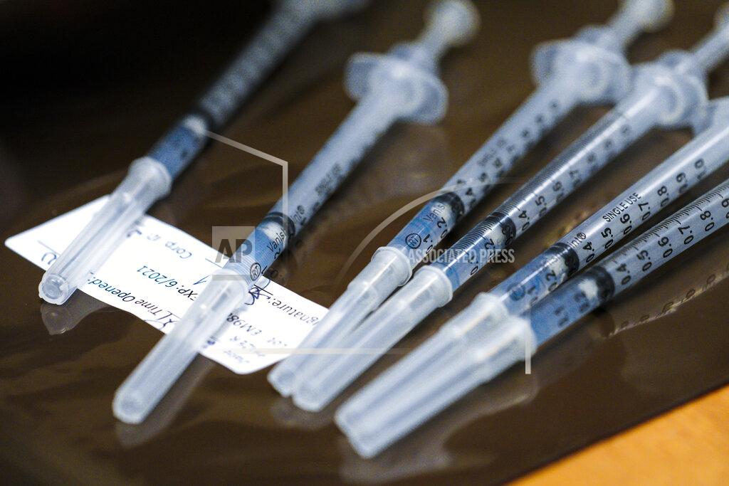 Nelvin C. Cepeda Scripps Health officially opened their new drive-thru vaccination site at the Del Mar Fairgrounds on Friday, Feb. 12, 2021 in Del Mar, Calif. In the pharmacy area, a pharmacist draws the vaccine into syringes for the healthcare professionals who are doing the inoculations. (Nelvin C. Cepeda/The San Diego Union-Tribune via AP, Pool)
