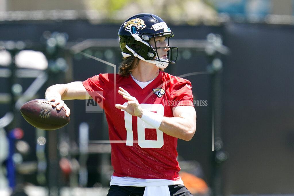 John Raoux Jacksonville Jaguars quarterback Trevor Lawrence looks for a receiver during an NFL football rookie minicamp, Saturday, May 15, 2021, in Jacksonville, Fla. (AP Photo/John Raoux)