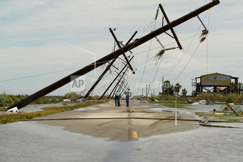 Eric Gay People survey the damage left in the wake of Hurricane Laura Thursday, Aug. 27, 2020, in Holly Beach, La. (AP Photo/Eric Gay)