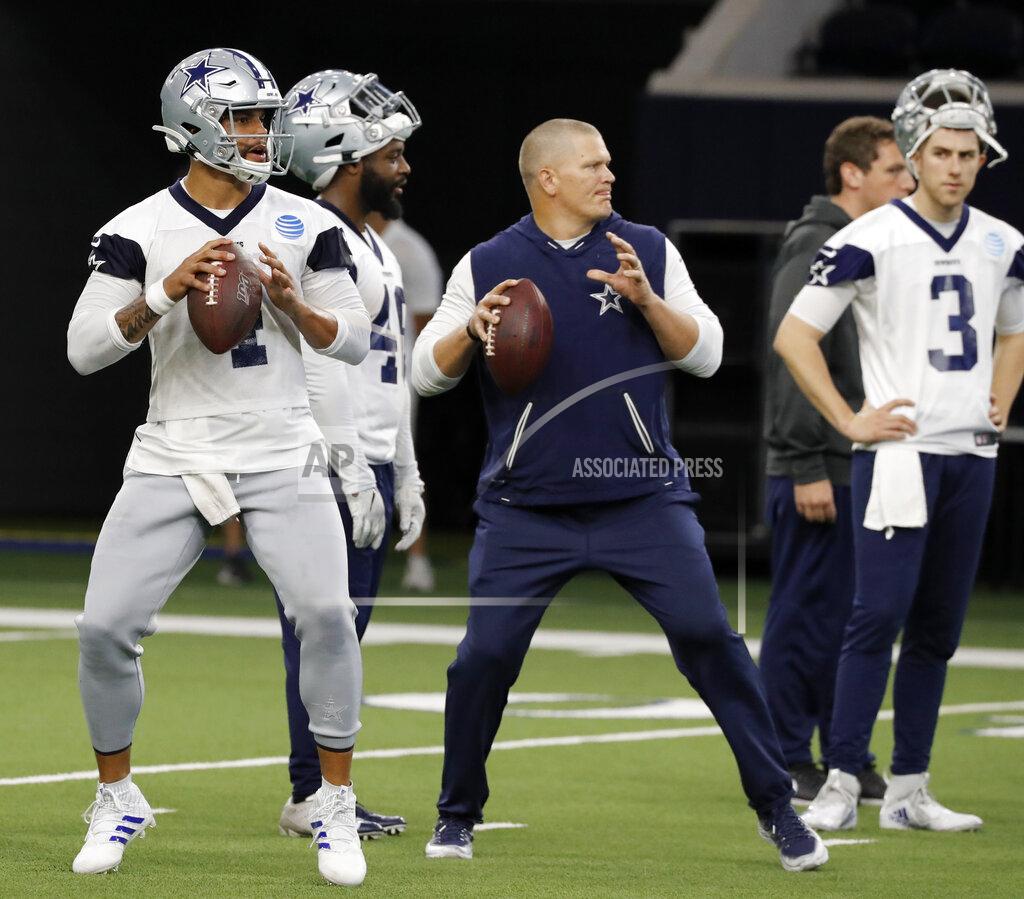 Tony Gutierrez Dallas Cowboys quarterback Dak Prescott (4) and quarterbacks coach Jon Kitna, center, prepare to throw passes as quarterback Mike White (3) looks on during drills at the team's NFL football training facility in Frisco, Texas, Wednesday, June 12, 2019. (AP Photo/Tony Gutierrez