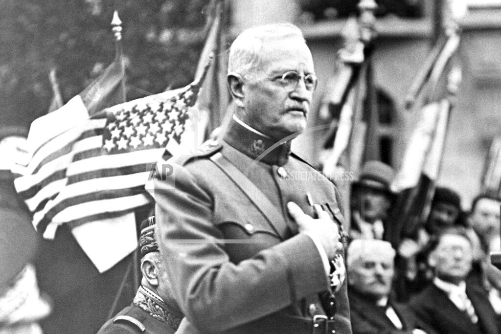 FILE - In this Sept. 15, 1935, file photo, General John J. Pershing makes a speech during the ceremony of planting an oak tree named after him to celebrate his 75th birthday and the 17th anniversary of the battle of St Mihiel, in St Mihiel, France. In the aftermath of World War I, 14 countries competed in the Inter-Allied Games in 1919, in a stadium named for Pershing, commander of the American Expeditionary Force in Europe. (AP Photo/File)