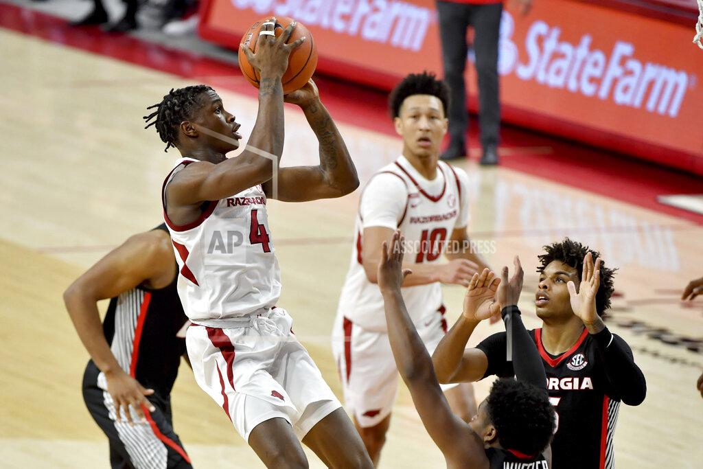 Michael Woods Arkansas guard Davonte Davis (4) shoots the ball over Georgia defenders during the second half of an NCAA college basketball game Saturday, Jan. 9, 2021, in Fayetteville, Ark. (AP Photo/Michael Woods)