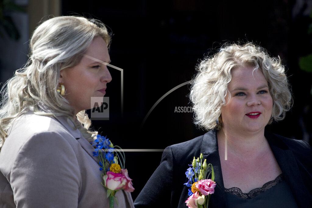 Peter Dejong Jeanette, left, and Romy Van Nus answer questions during an interview after their wedding ceremony in Utrecht, Netherlands, Thursday, April 1, 2021. Twenty years ago, on April 1, 2001, the mayor of Amsterdam married four couples in City Hall as the Netherlands became the first country in the world with legalized same-sex marriage. It's now legal in 28 countries. (AP Photo/Peter Dejong)