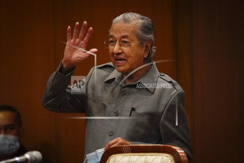 Vincent Thian Malaysia former Prime Minister Mahathir Mohamad waves after a press conference at his office of Perdana Foundation in Putrajaya, Malaysia, on Monday, May 18, 2020. Mahathir slammed the government for using the pandemic as an excuse to block parliament from sitting. The king in his speech urged lawmakers not to stir up another political crisis but to focus on the people's welfare amid the virus outbreak. (AP Photo/Vincent Thian)