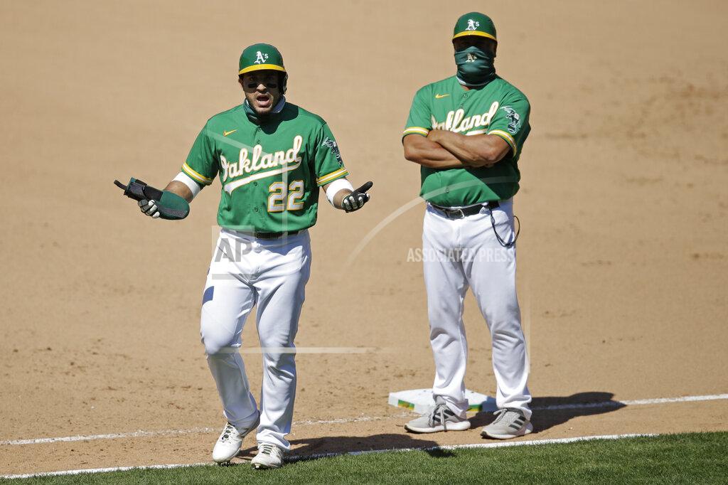 Ben Margot Oakland Athletics' Ramon Laureano (22) gestures toward the Houston Astros dugout before charging it after being hit by a pitch thrown by Humberto Castellanos in the seventh inning of a baseball game Sunday, Aug. 9, 2020, in Oakland, Calif. (AP Photo/Ben Margot)