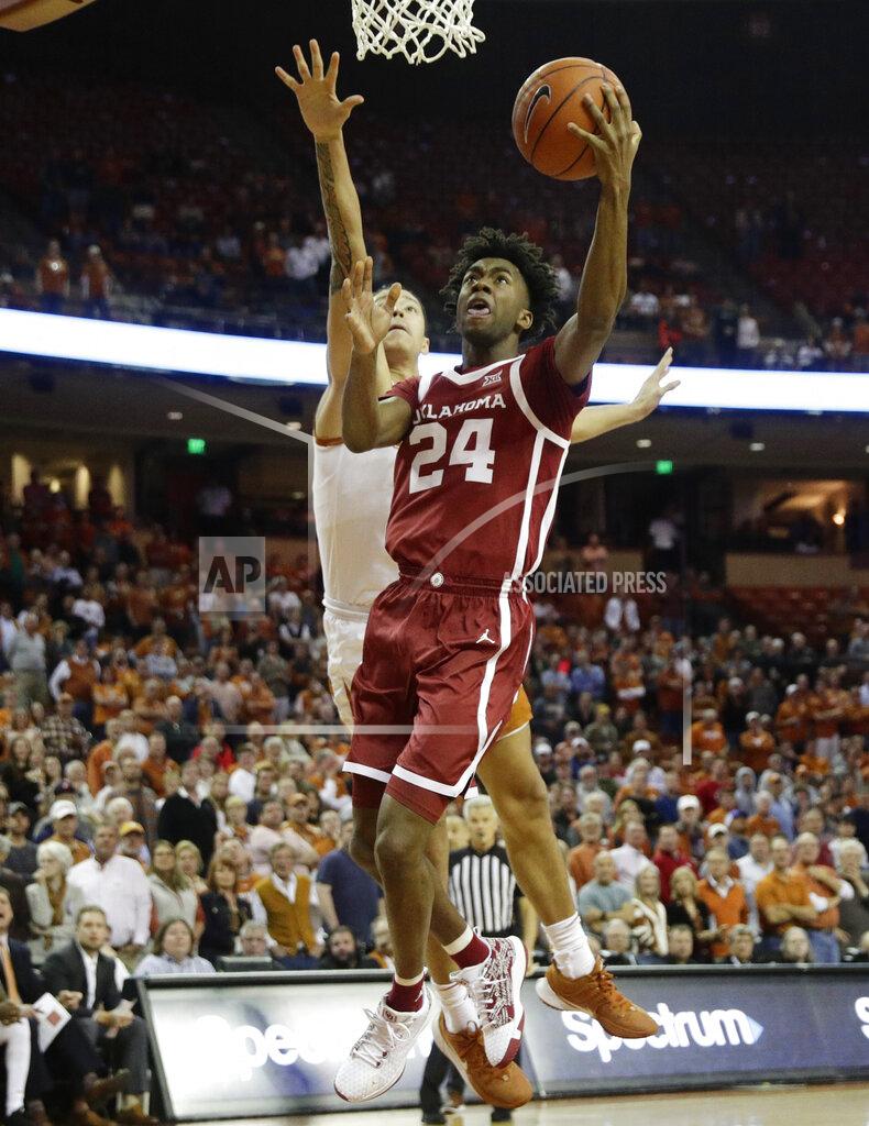 Eric Gay Oklahoma guard Jamal Bieniemy (24) scores past Texas forward Kamaka Hepa (33) during the first half of an NCAA college basketball game in Austin, Texas, Wednesday, Jan. 8, 2020. (AP Photo/Eric Gay)