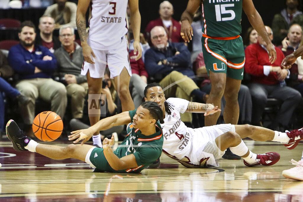 Phil Sears Miami guard Isaiah Wong (2) makes an outlet pass after coming up with a loose ball as Florida State guard Caleb Mills (4) watches in the first half of an NCAA college basketball game in Tallahassee, Fla., Tuesday, Jan. 24, 2023. (AP Photo/Phil Sears)