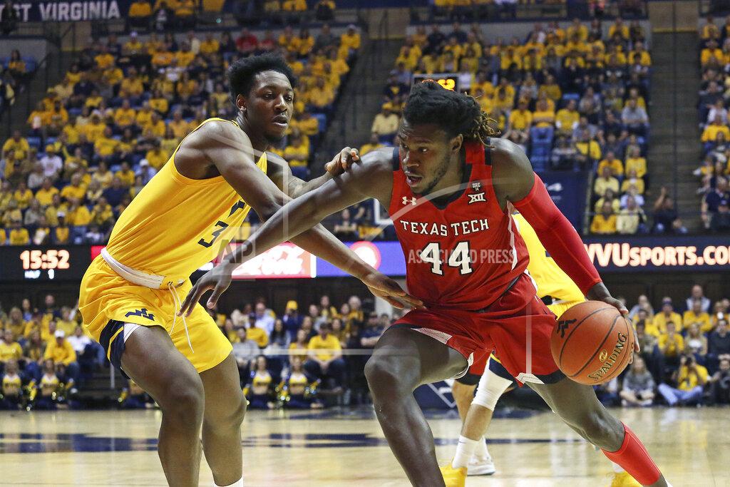 Kathleen Batten Texas Tech guard Chris Clarke (44) runs upcourt as he is defended by West Virginia forward Gabe Osabuohien (3) during the first half of an NCAA college basketball game Saturday, Jan. 11, 2020, in Morgantown, W.Va. (AP Photo/Kathleen Batten)