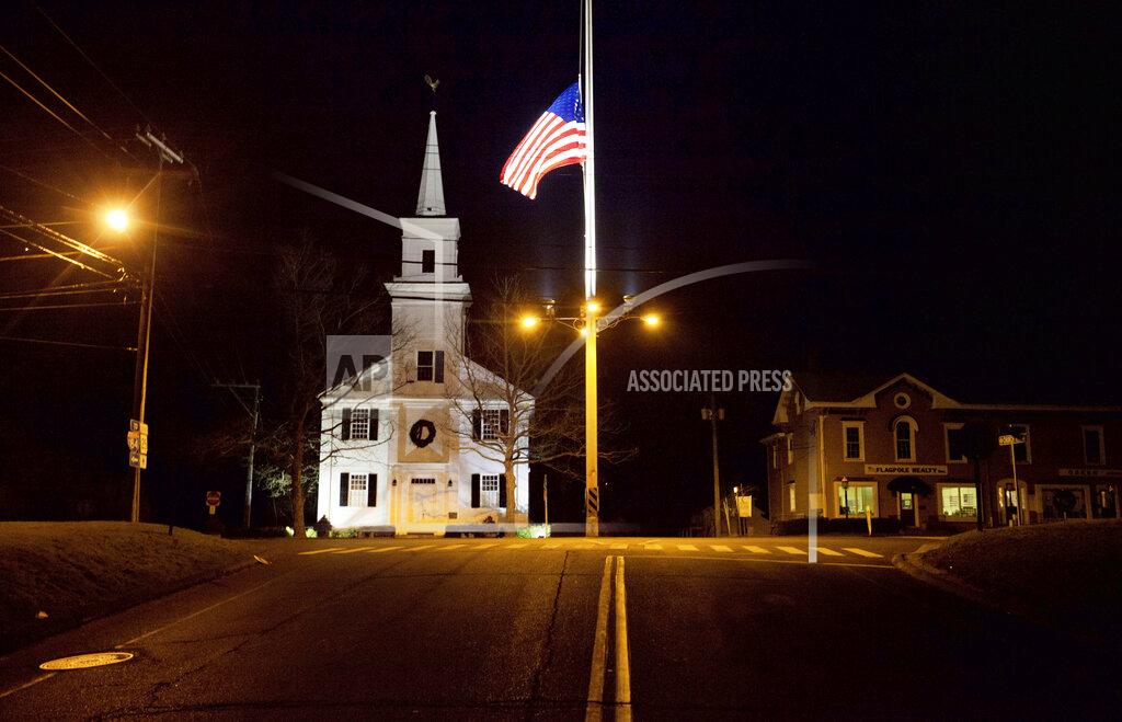 David Goldman FILE - In this Dec. 15, 2012 file photo, a U.S. flag flies at half-staff on Main Street in Newtown, Conn., in honor of the 26 students and staff killed in a shooting at the Sandy Hook Elementary school. Vigils and church services were held Saturday, Dec. 14, 2019, in Newtown to mark the seventh anniversary of the Dec. 14, 2012, shooting and remember victims of other gun violence. (AP Photo/David Goldman, File)